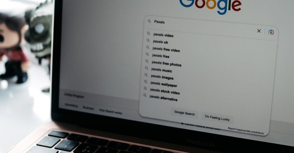 A close-up shot of a laptop displaying a Google search page with related searches visible.